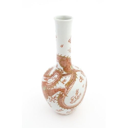 2 - A Chinese bottle vase decorated with a dragon, flaming pearl, stylised clouds and waves. Character m... 