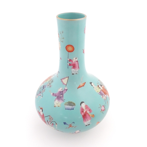 6 - A Chinese famille rose vase with a turquoise ground decorated with figures and auspicious symbols. C... 