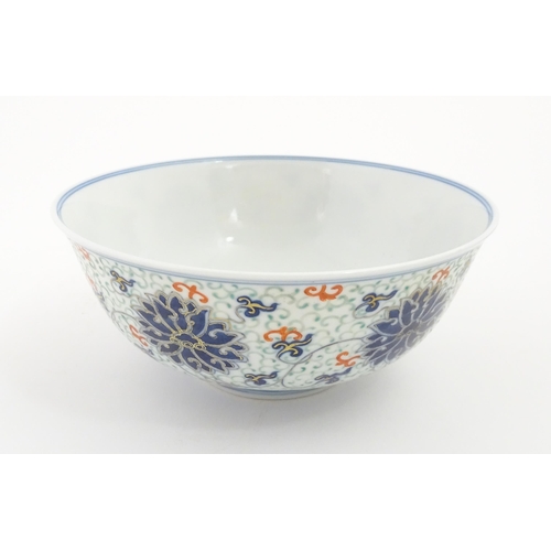 11 - A Chinese bowl decorated with scrolling floral and foliate detail. Character marks under. Approx. 3