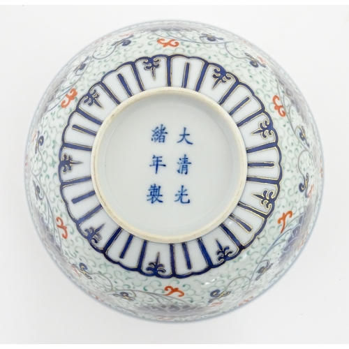 11 - A Chinese bowl decorated with scrolling floral and foliate detail. Character marks under. Approx. 3