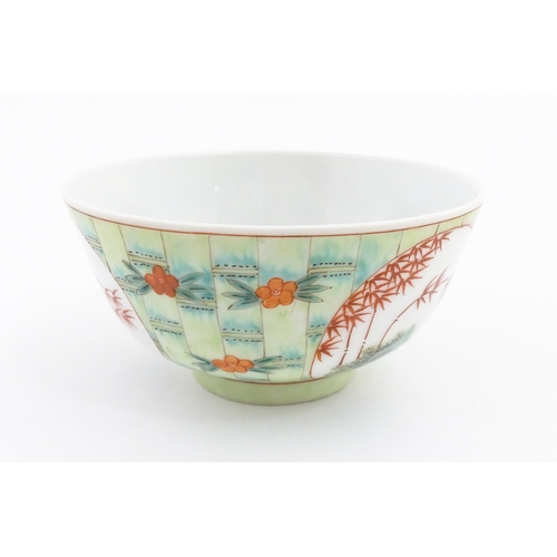 16 - A Chinese famille verte bowl decorated with stylised bamboo and flowers. Character marks under. Appr... 