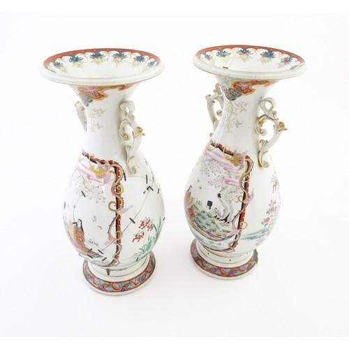 24 - A pair of Japanese vases with flared rim and twin handles, decorated with a vignette depicting figur... 