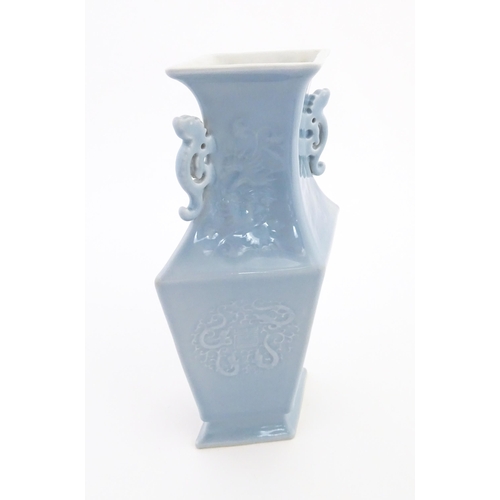 25 - A Chinese vase of angular baluster form with a pale blue ground and twin handles, decorated with pho... 