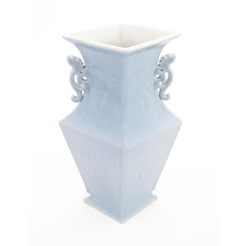 25 - A Chinese vase of angular baluster form with a pale blue ground and twin handles, decorated with pho... 