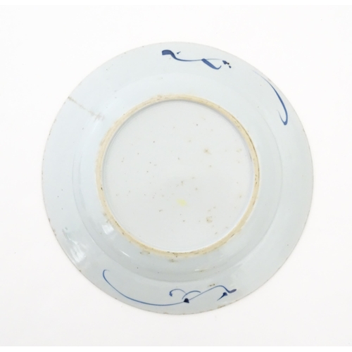 30 - A Chinese blue and white plate decorated with flowers and foliage, with brushwork detail to reverse.... 