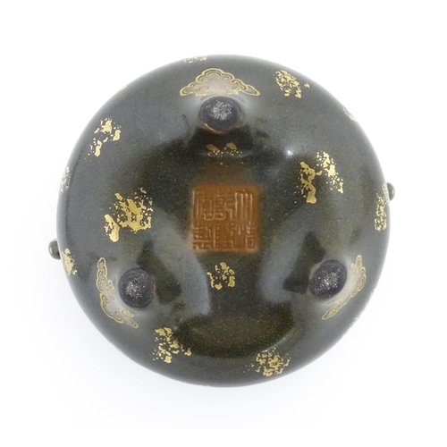 48 - A small Chinese censer with twin handles with banded decoration in relief depicting stylised dragons... 