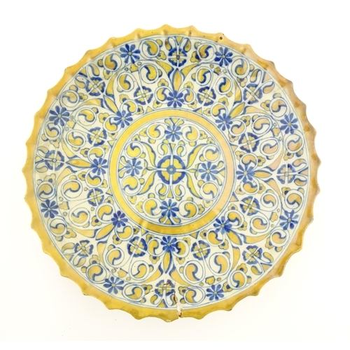 105 - An Italian Cantagalli lustre charger decorated with scrolling floral and foliate detail in blue and ... 