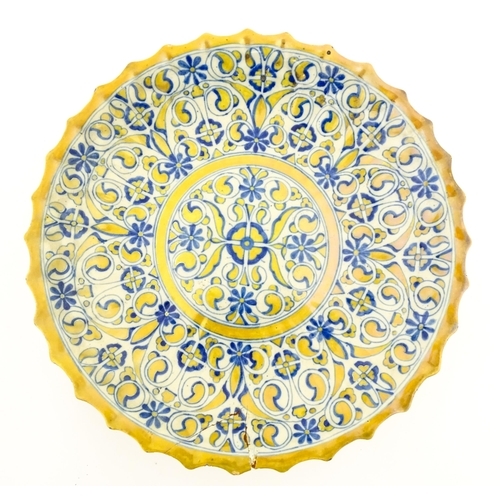 105 - An Italian Cantagalli lustre charger decorated with scrolling floral and foliate detail in blue and ... 