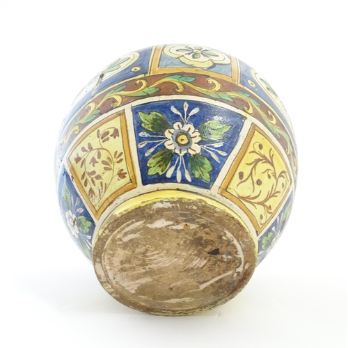 141 - A Sicilian maiolica Bombola vase with panelled and banded decoration depicting flowers and foliage. ... 