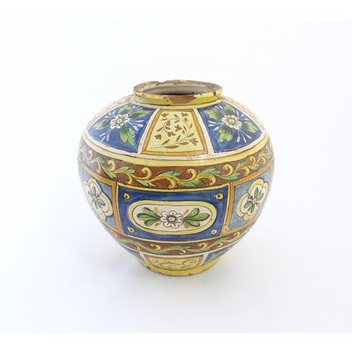 141 - A Sicilian maiolica Bombola vase with panelled and banded decoration depicting flowers and foliage. ... 