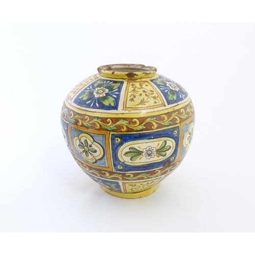 141 - A Sicilian maiolica Bombola vase with panelled and banded decoration depicting flowers and foliage. ... 