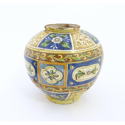 141 - A Sicilian maiolica Bombola vase with panelled and banded decoration depicting flowers and foliage. ... 