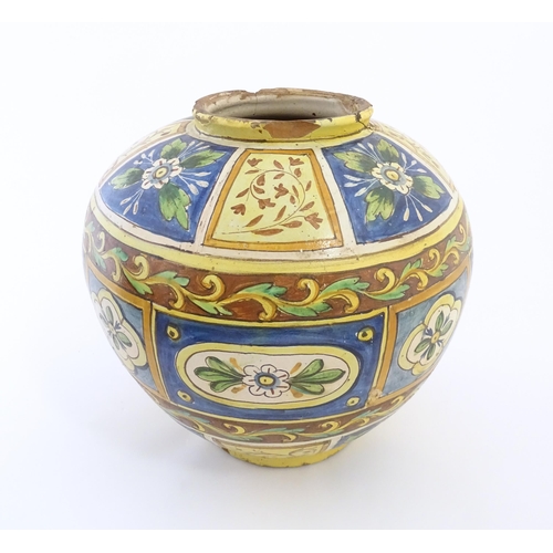 141 - A Sicilian maiolica Bombola vase with panelled and banded decoration depicting flowers and foliage. ... 