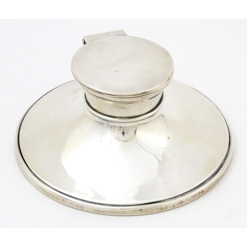 229 - A silver inkwell of capstan form hallmarked London 1922, maker Charles Boyton & Sons Ltd. Approx. 5