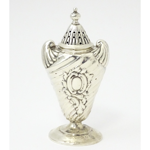 328 - A Victorian silver pepper with embossed decoration. Hallmarked Birmingham 1890. Approx 4