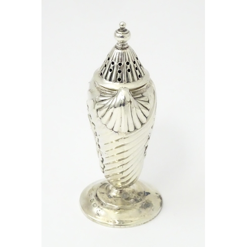 328 - A Victorian silver pepper with embossed decoration. Hallmarked Birmingham 1890. Approx 4