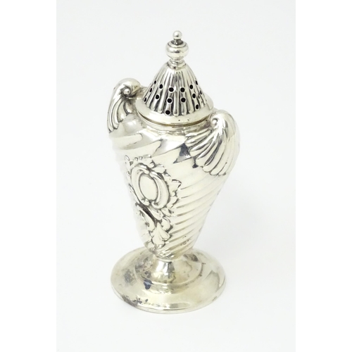 328 - A Victorian silver pepper with embossed decoration. Hallmarked Birmingham 1890. Approx 4