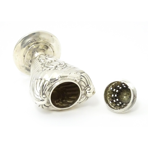 328 - A Victorian silver pepper with embossed decoration. Hallmarked Birmingham 1890. Approx 4