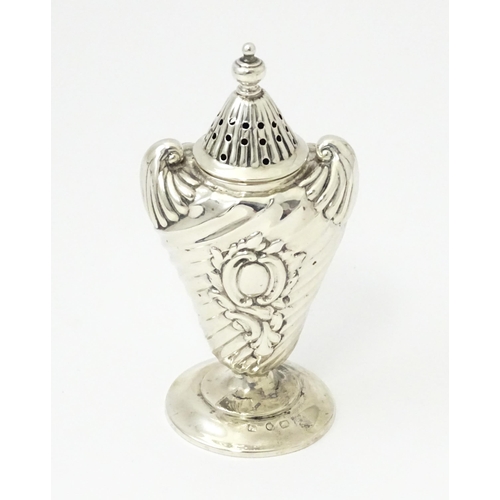 328 - A Victorian silver pepper with embossed decoration. Hallmarked Birmingham 1890. Approx 4