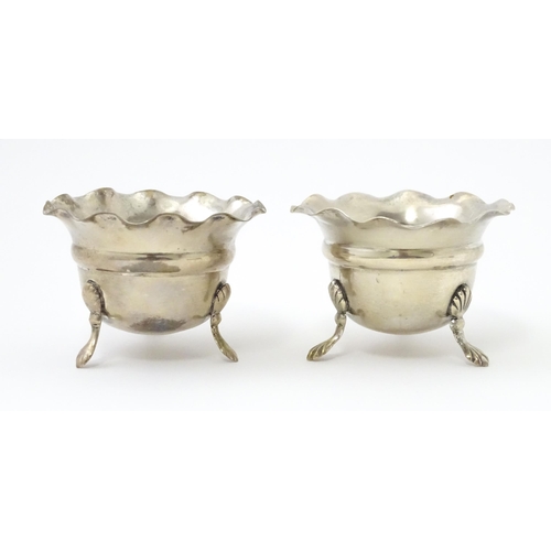 334 - A pair of silver salts with crimped rims and raised on 3 paw feet. Hallmarked Birmingham 1931 maker ... 