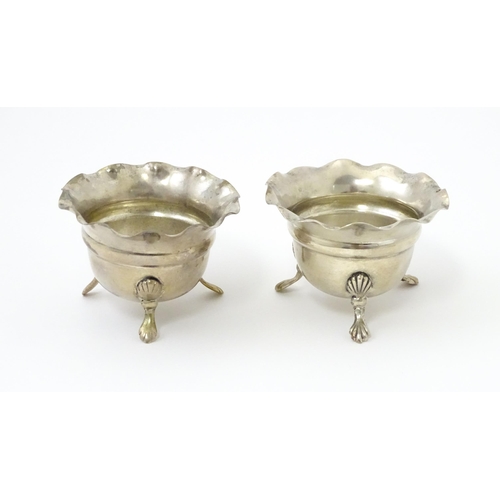 334 - A pair of silver salts with crimped rims and raised on 3 paw feet. Hallmarked Birmingham 1931 maker ... 