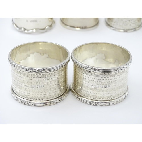 335 - Seven assorted silver napkin rings, various dates and makers to include an Art Deco example hallmark... 