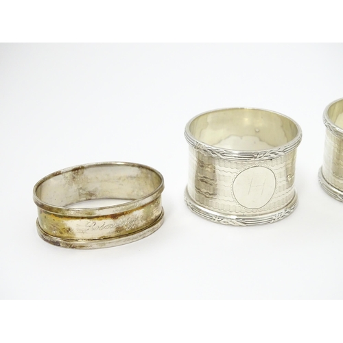 335 - Seven assorted silver napkin rings, various dates and makers to include an Art Deco example hallmark... 