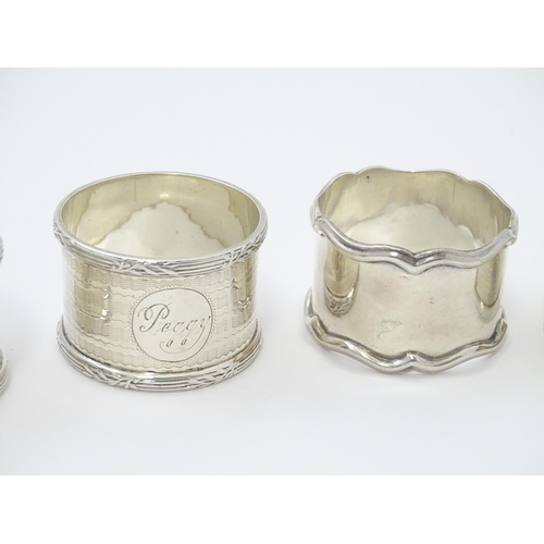 335 - Seven assorted silver napkin rings, various dates and makers to include an Art Deco example hallmark... 