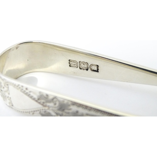 429 - Silver sugar tongs with bright cut engraved decoration Hallmarked London 1901 maker Josiah Williams ... 