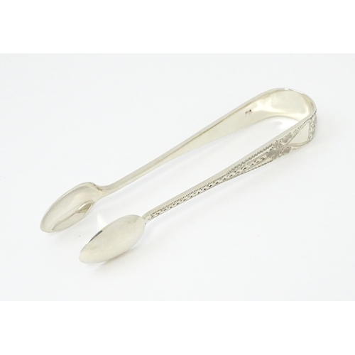 429 - Silver sugar tongs with bright cut engraved decoration Hallmarked London 1901 maker Josiah Williams ... 