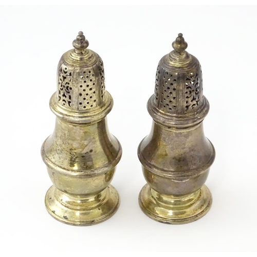 234 - A pair of silver pepperettes hallmarked London 1928 / 1929, maker William Comyns & Sons Ltd. Approx.... 