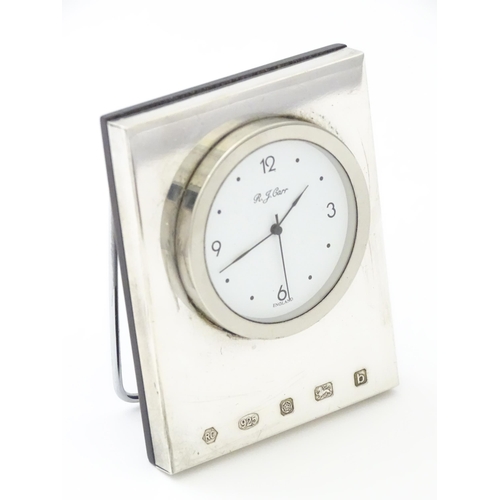 236 - An easel back clock with a silver surround hallmarked Sheffield 2001, maker Carrs of Sheffield. Appr... 