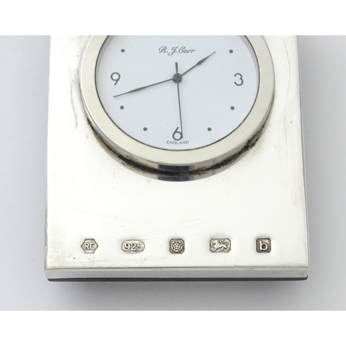 236 - An easel back clock with a silver surround hallmarked Sheffield 2001, maker Carrs of Sheffield. Appr... 