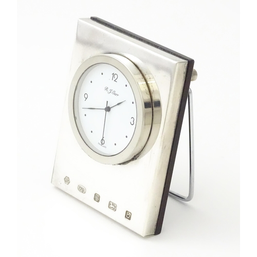 236 - An easel back clock with a silver surround hallmarked Sheffield 2001, maker Carrs of Sheffield. Appr... 