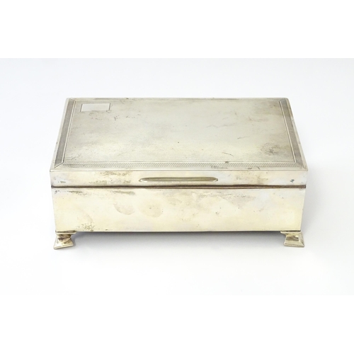 239 - A silver table top cigarette box with engine turned decoration opening to reveal a cedar lined inter... 