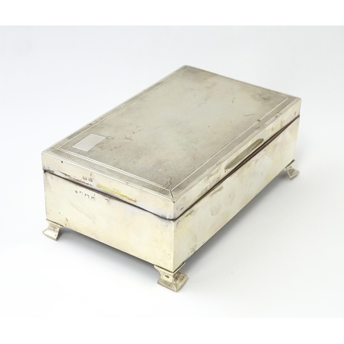 239 - A silver table top cigarette box with engine turned decoration opening to reveal a cedar lined inter... 