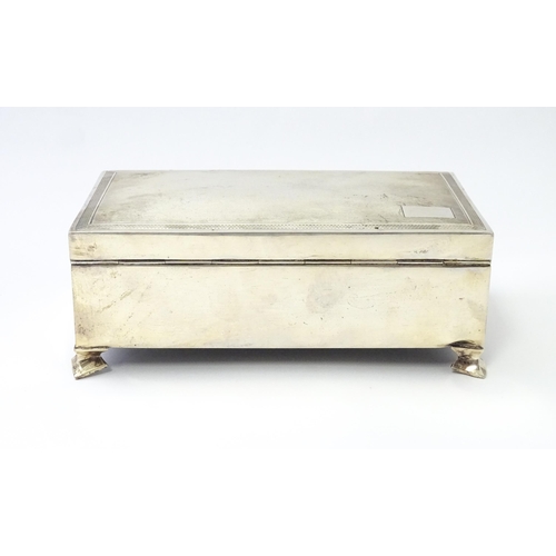 239 - A silver table top cigarette box with engine turned decoration opening to reveal a cedar lined inter... 