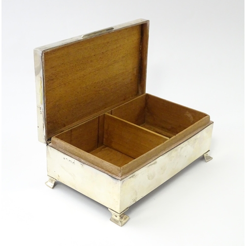 239 - A silver table top cigarette box with engine turned decoration opening to reveal a cedar lined inter... 