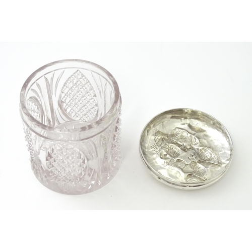 240 - A cut glass dressing table jar with silver top with embossed angel detail, hallmarked Birmingham 190... 