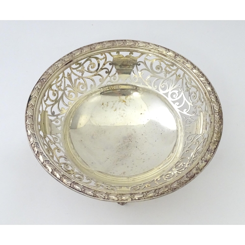 244 - A large silver bon bon dish / fruit dish with pierced scroll detail, standing on four lion paw feet,... 