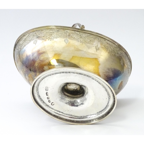 245 - A Geo III silver sugar basket with swing handle hallmarked London 1790, maker Henry Chawner. Approx.... 