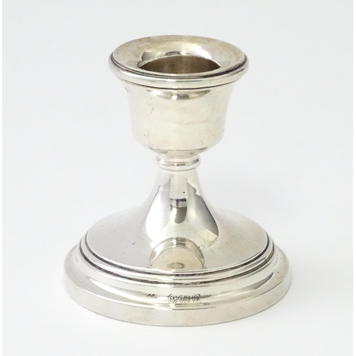 263 - A silver candlestick of squat form, hallmarked Birmingham 1929. Approx. 2 1/4