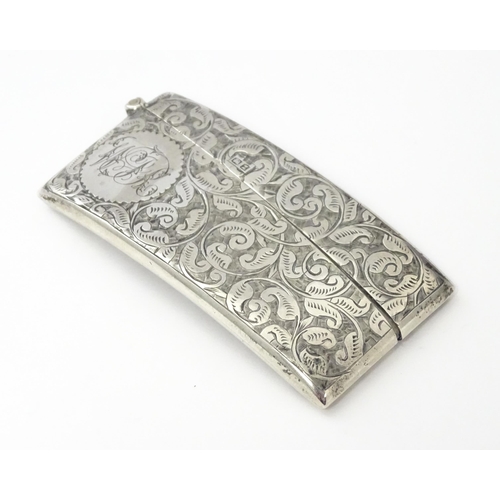 267 - A Victorian silver card case of shaped form with engraved acanthus scroll detail, hallmarked Birming... 