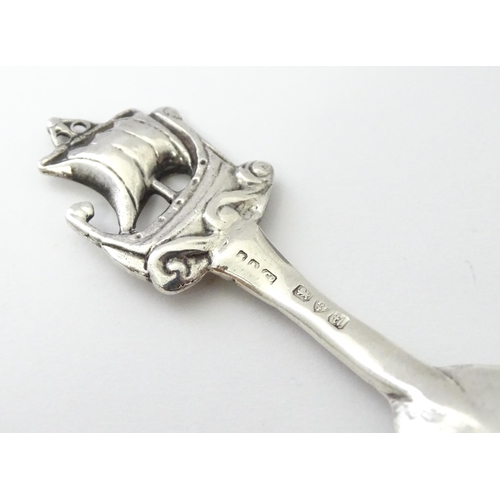 268 - A silver caddy spoon with hammered decoration and Ionia style boat finial and Celtic detail to handl... 