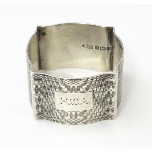 269 - A silver napkin ring with engine turned decoration hallmarked Birmingham 1938, maker Robert Pringle ... 