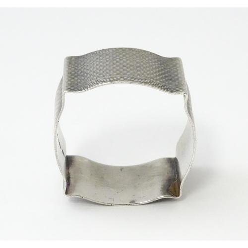 269 - A silver napkin ring with engine turned decoration hallmarked Birmingham 1938, maker Robert Pringle ... 