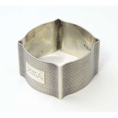 269 - A silver napkin ring with engine turned decoration hallmarked Birmingham 1938, maker Robert Pringle ... 