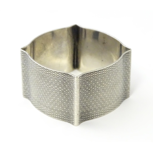 269 - A silver napkin ring with engine turned decoration hallmarked Birmingham 1938, maker Robert Pringle ... 