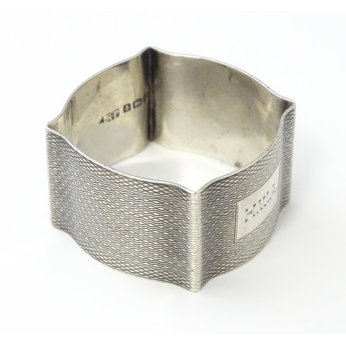 269 - A silver napkin ring with engine turned decoration hallmarked Birmingham 1938, maker Robert Pringle ... 