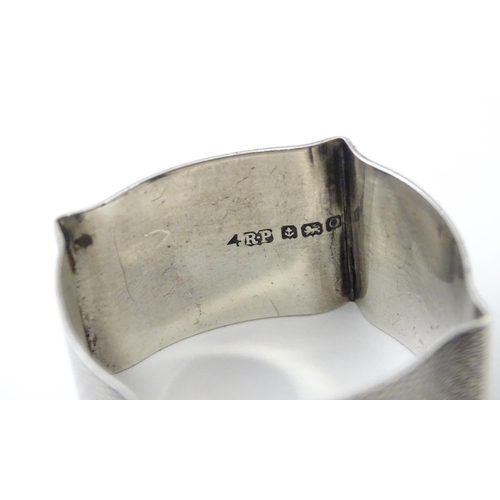 269 - A silver napkin ring with engine turned decoration hallmarked Birmingham 1938, maker Robert Pringle ... 